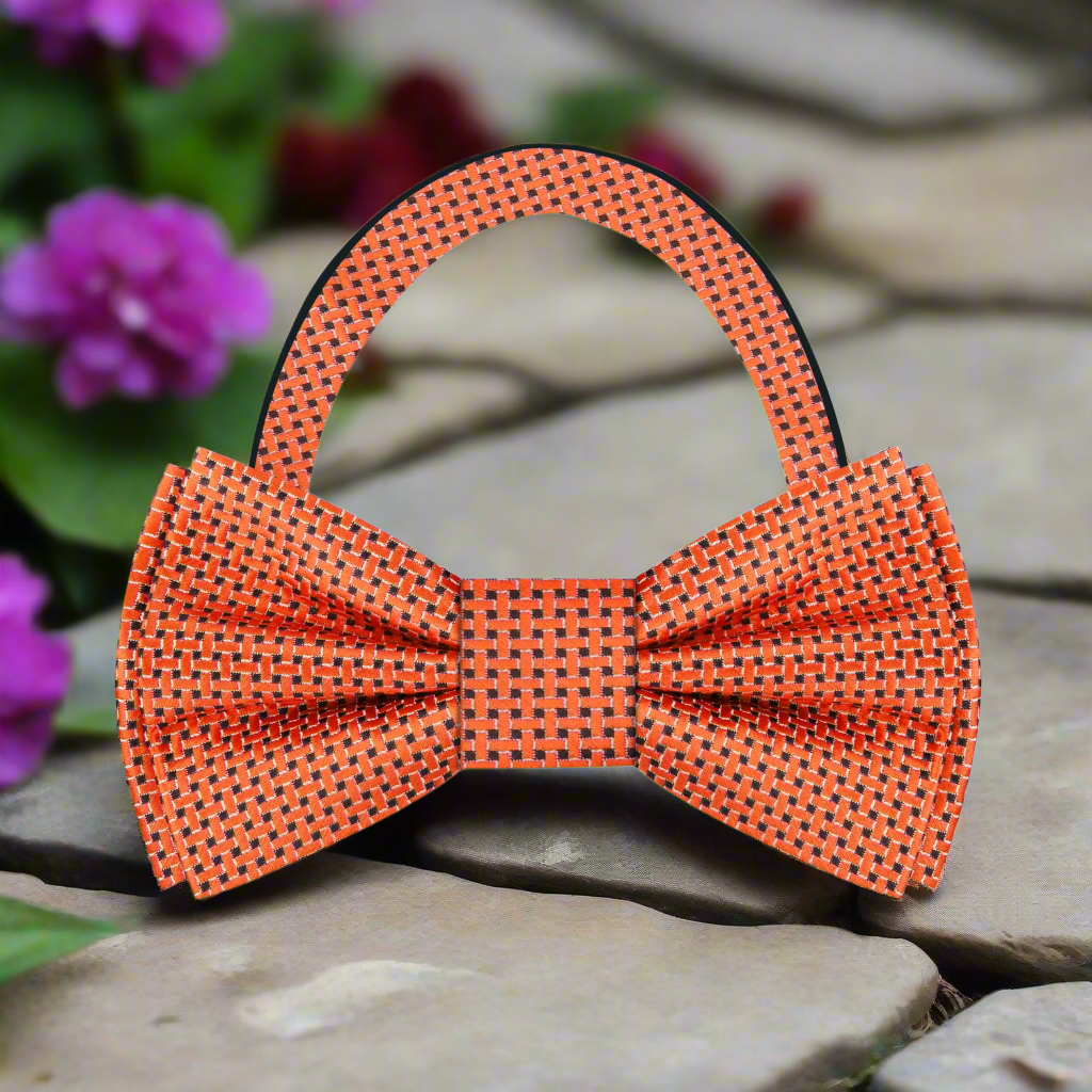 Close-up of the brown geometric bow tie with pocket square, highlighting the intricate silk pattern.