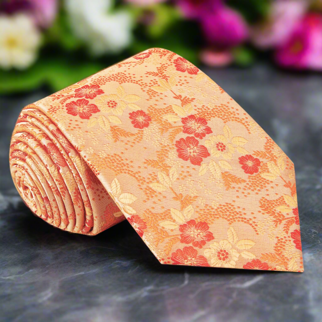 Charming orange floral necktie against a white background, showcasing intricate floral patterns.