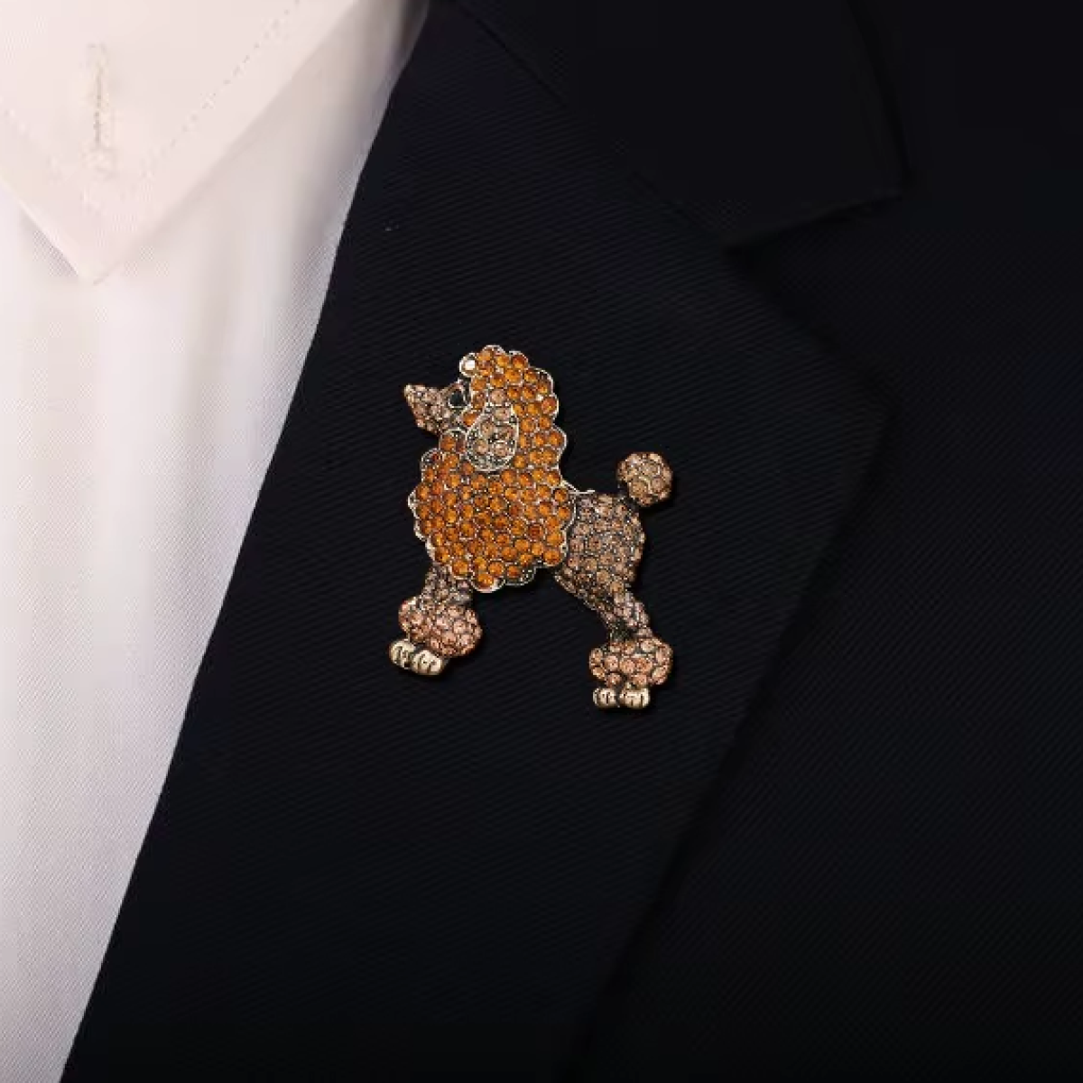 Both pink and orange poodle lapel pins arranged together, emphasizing their unique charm.