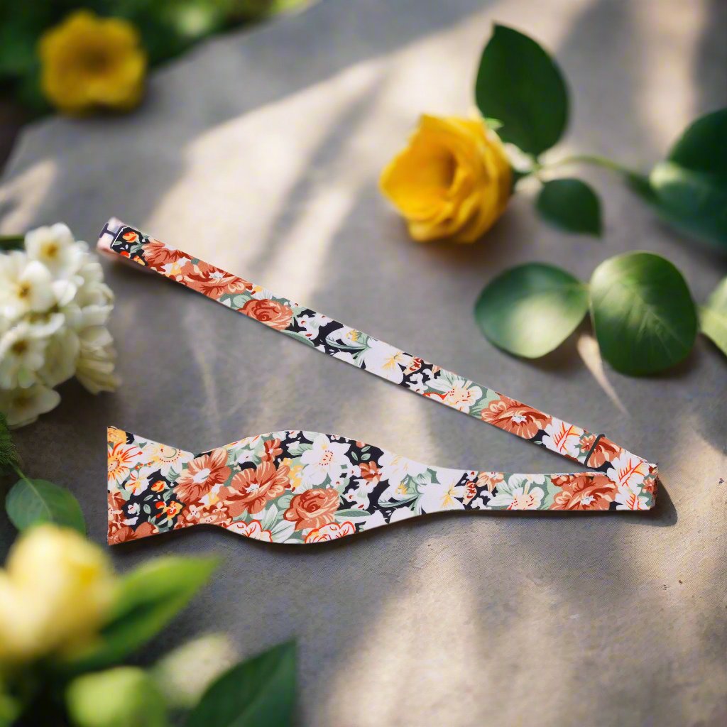 Close-up of a silk bow tie featuring a natural, hand-drawn floral design
