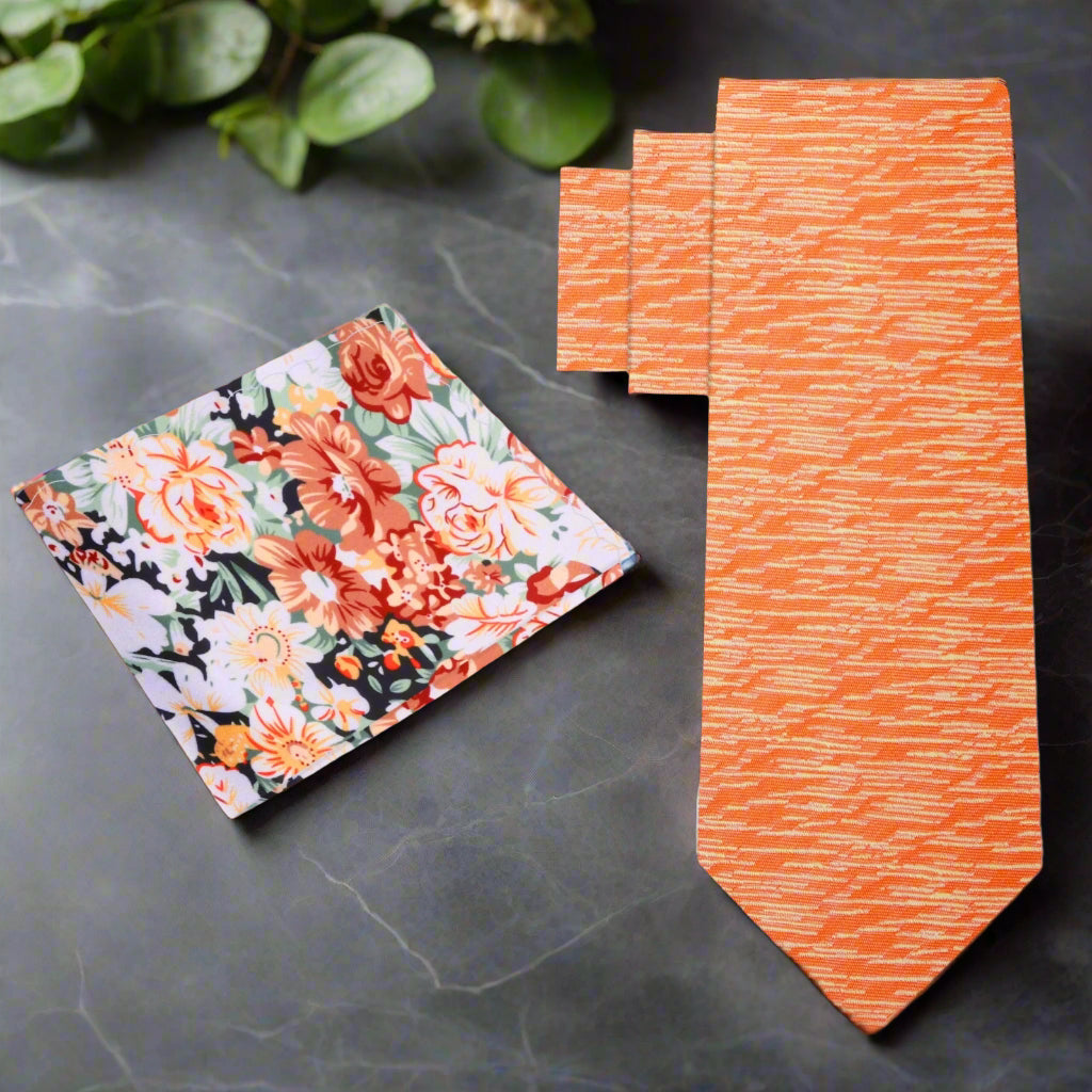 Close-up of the vibrant orange abstract silk necktie showing textured pattern