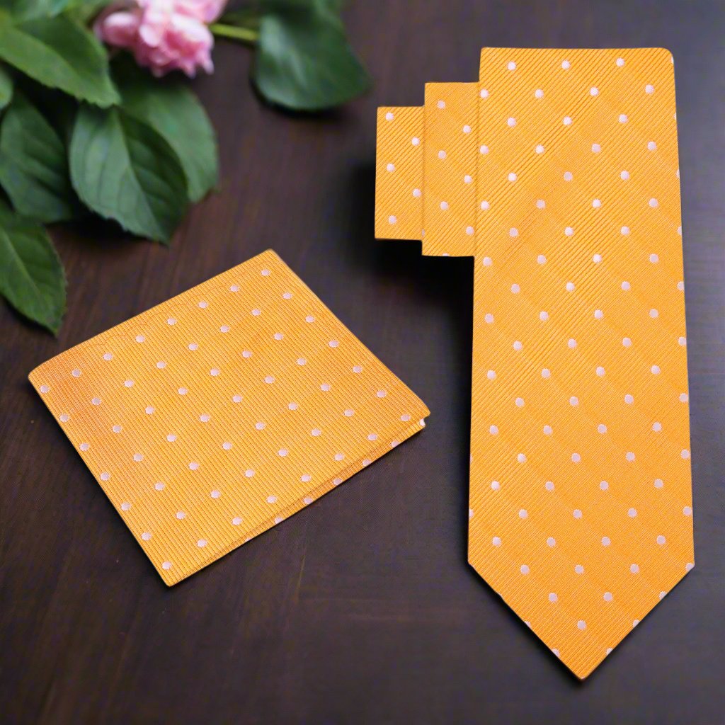 Man wearing a polka dot necktie with a matching pocket square, suited for weddings