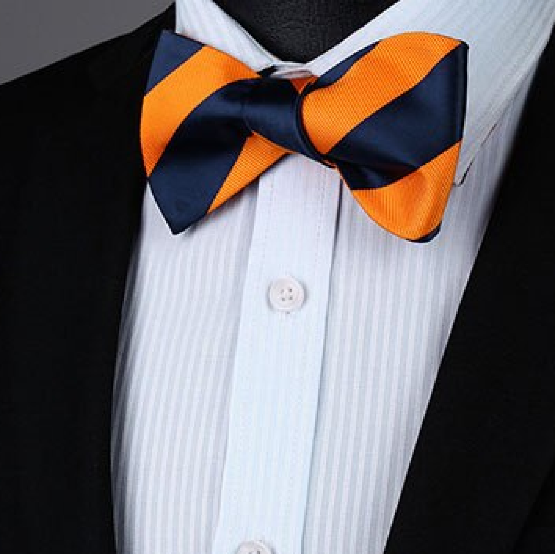 Styled shot of a striped bow tie and matching pocket square for cocktail party outfit