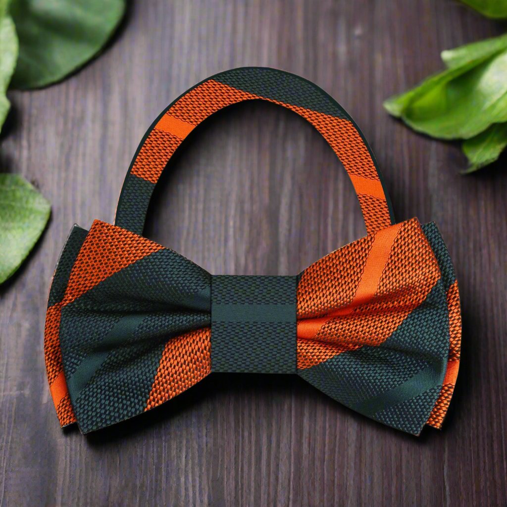 Fashionable mens striped silk bow tie paired with navy suit for formal events