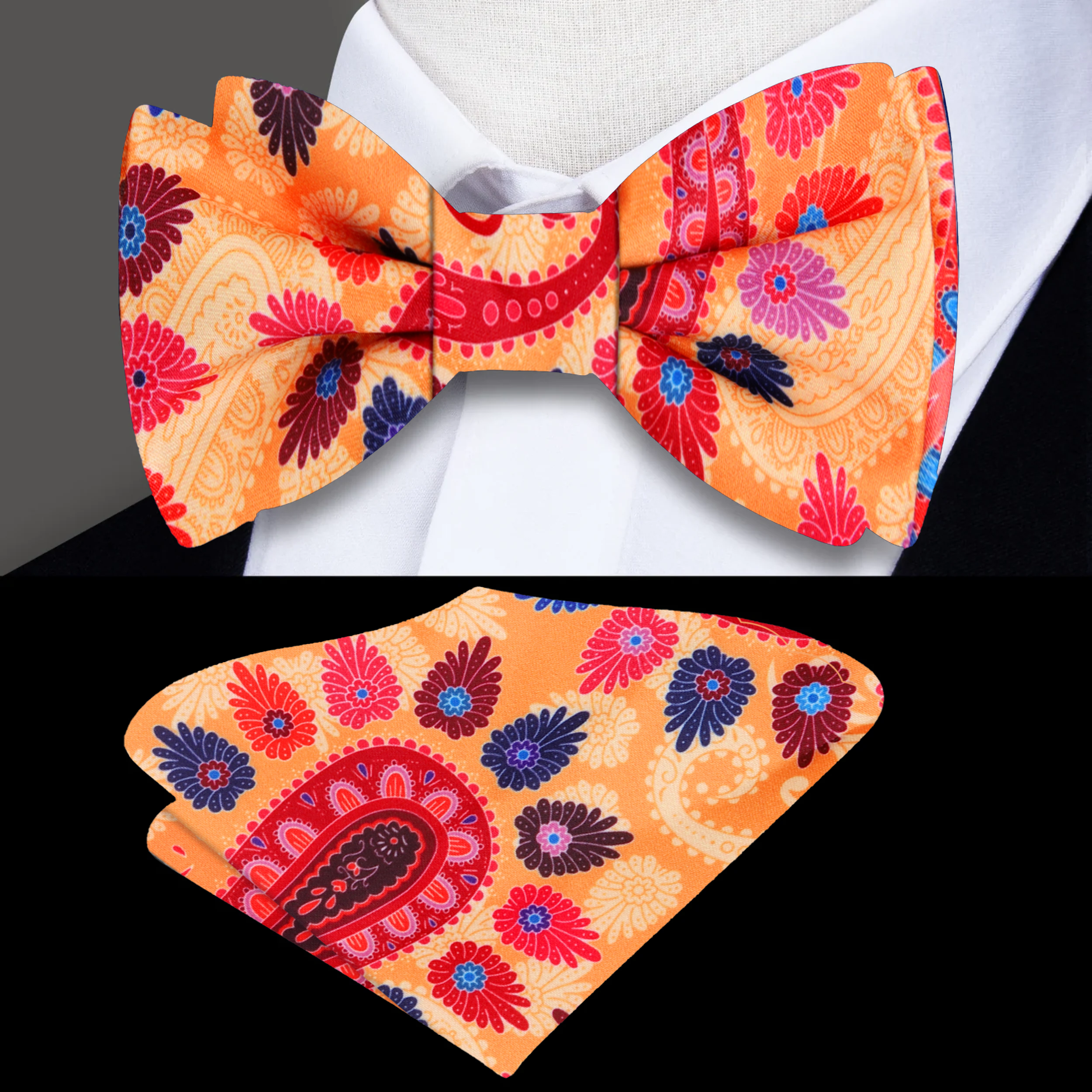 Close-up view of the vibrant paisley silk bow tie featuring intricate patterns in orange and red.