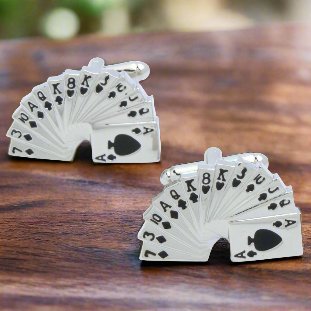 Close-up of chrome playing cards cufflinks on a dress shirt