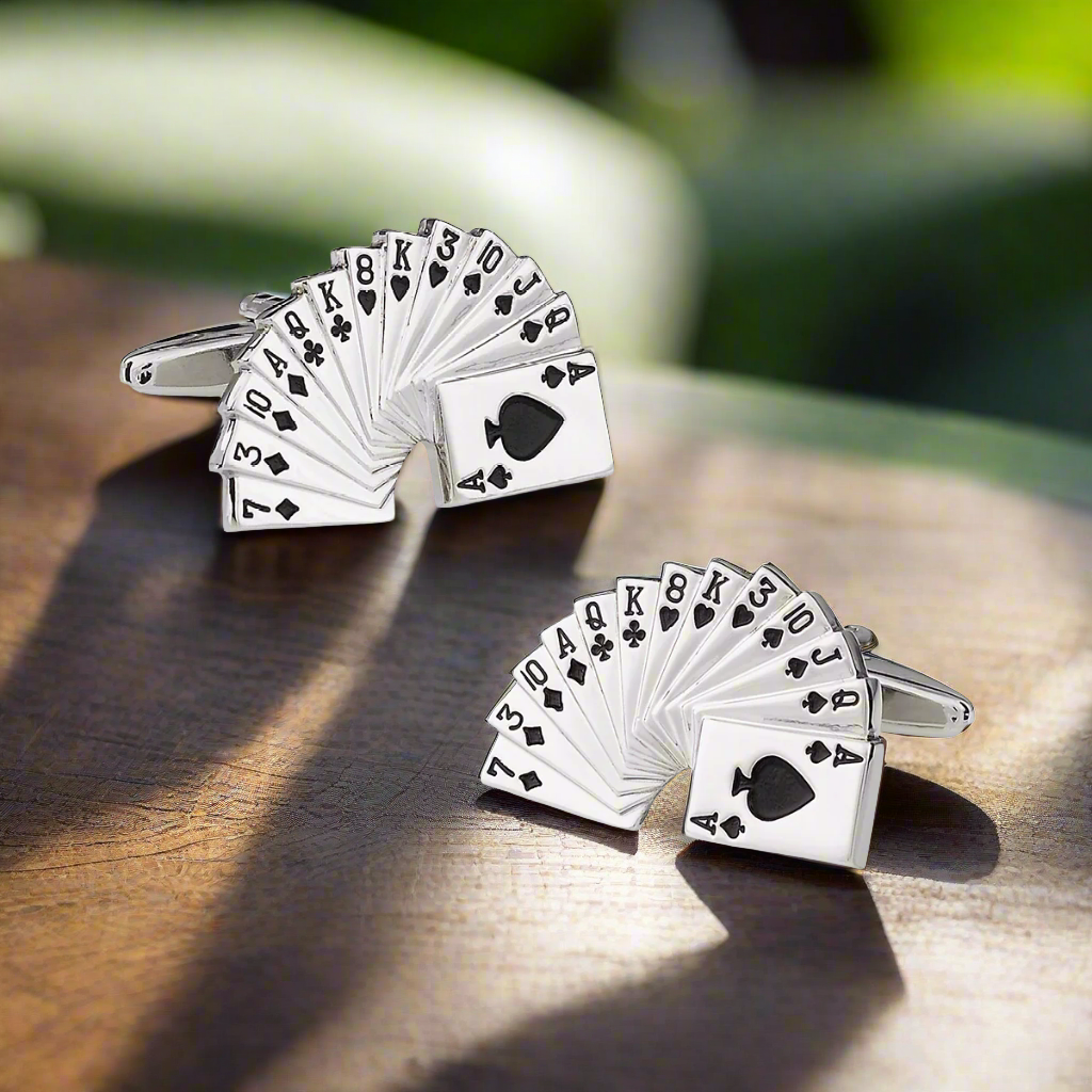 Close-up of chrome playing cards cufflinks on a dress shirt