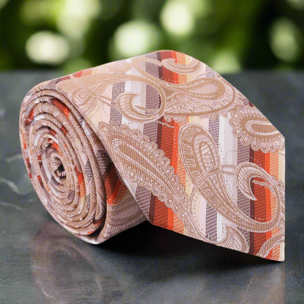 Close-up of the necktie's paisley and stripe pattern highlighting pale peach and yellow tones