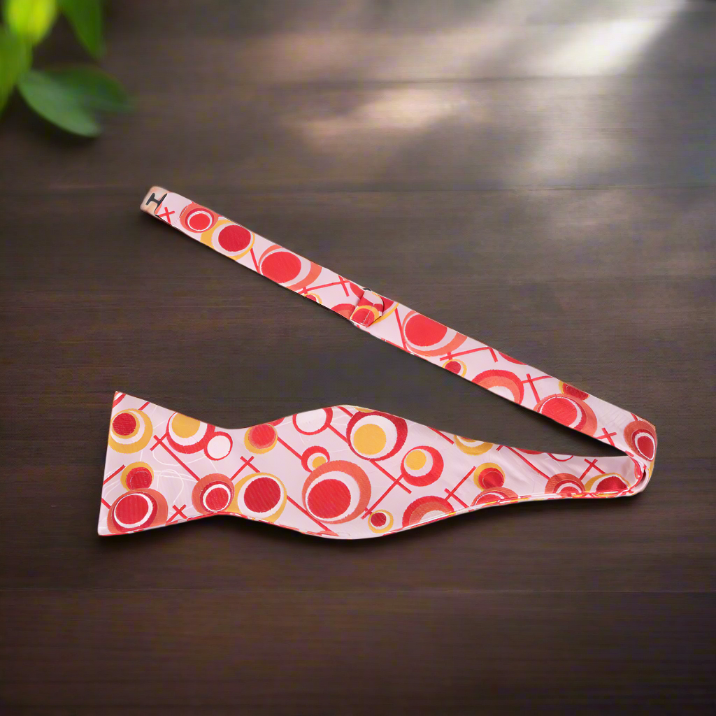 Close-up detail of the fabric pattern on the vibrant circles bow tie.