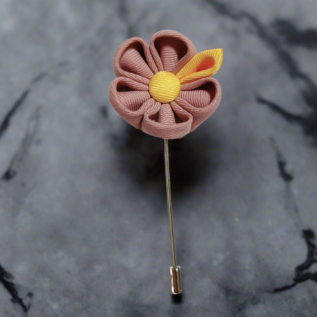 Elegant pink and yellow lapel pin on a men's suit for formal events