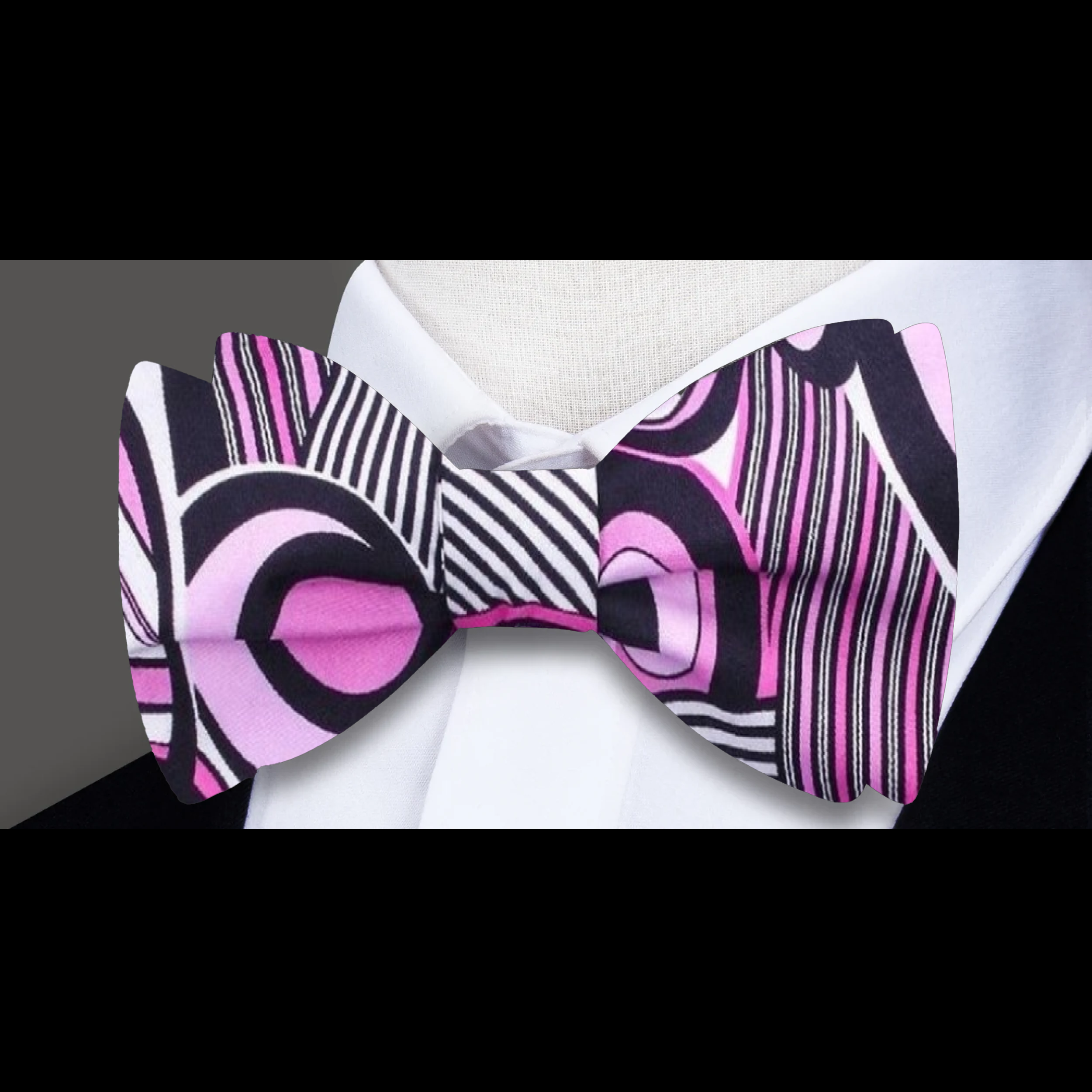 Model wearing a self-tie silk bow tie with matching pocket square at an art gallery event