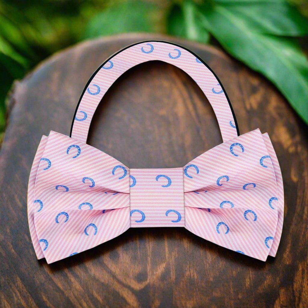 Light red silk bow tie with blue horseshoes pattern, perfect for derby day.