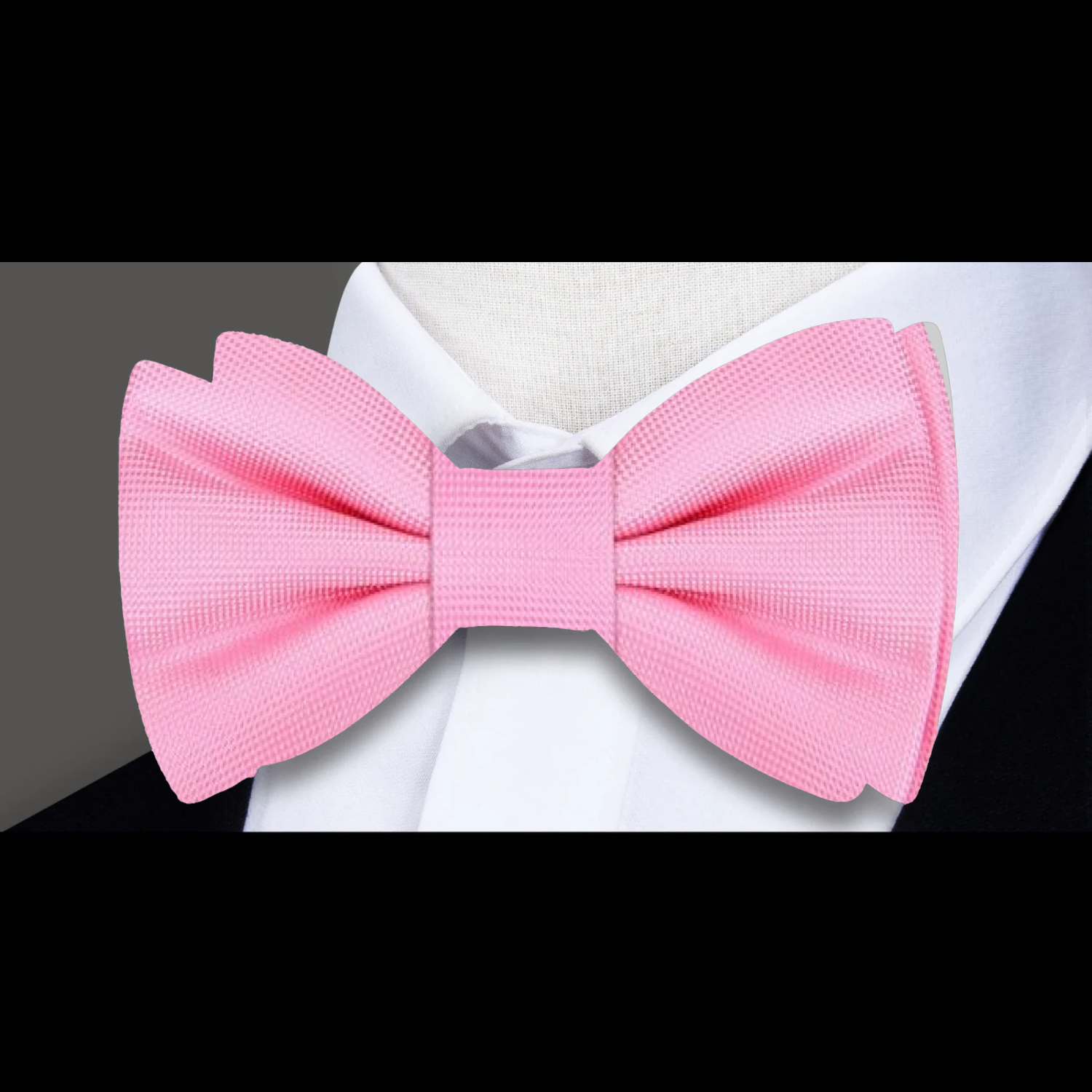 Elegant solid color bow tie in vibrant coral, perfect for weddings.