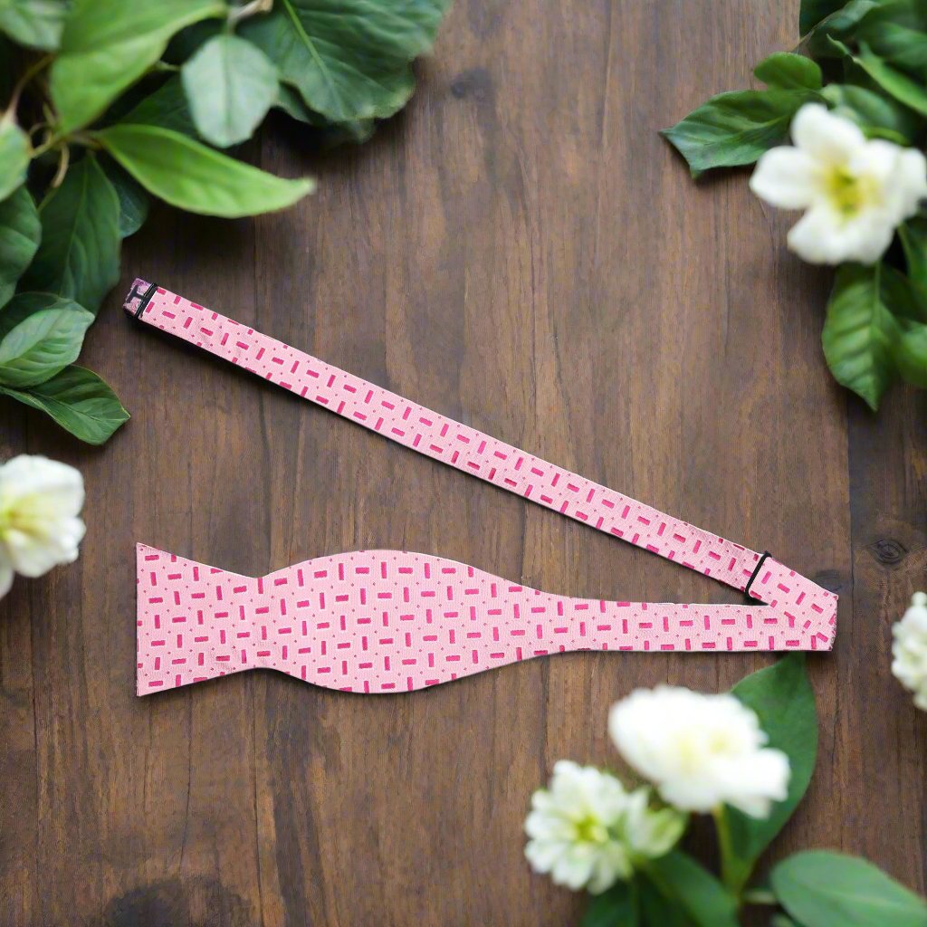 Front view of the charming pink silk bow tie with dark pink stripes, suitable for weddings.