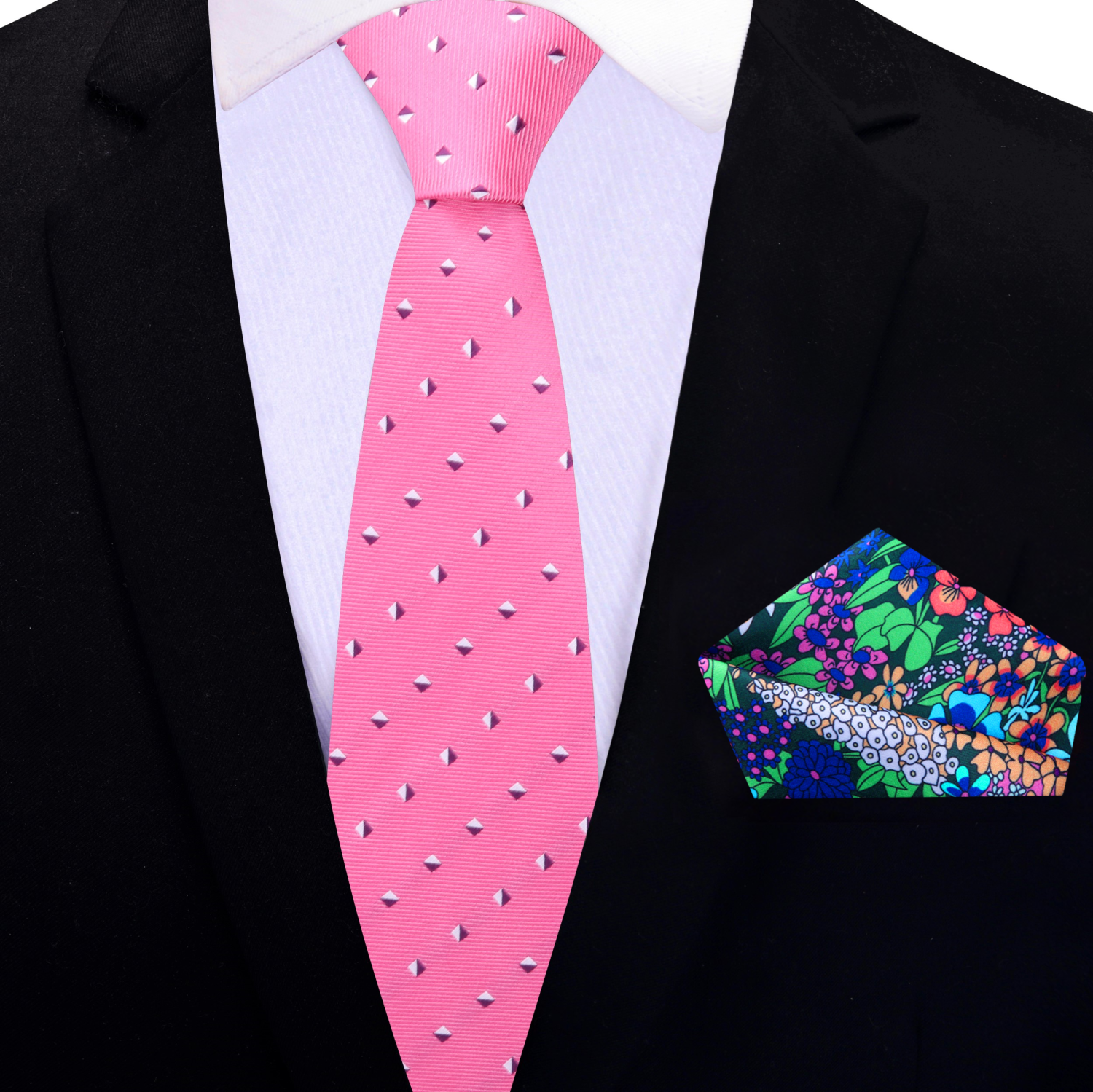 Styled look featuring the pink geometric silk tie paired with a navy blue suit at a wedding event.