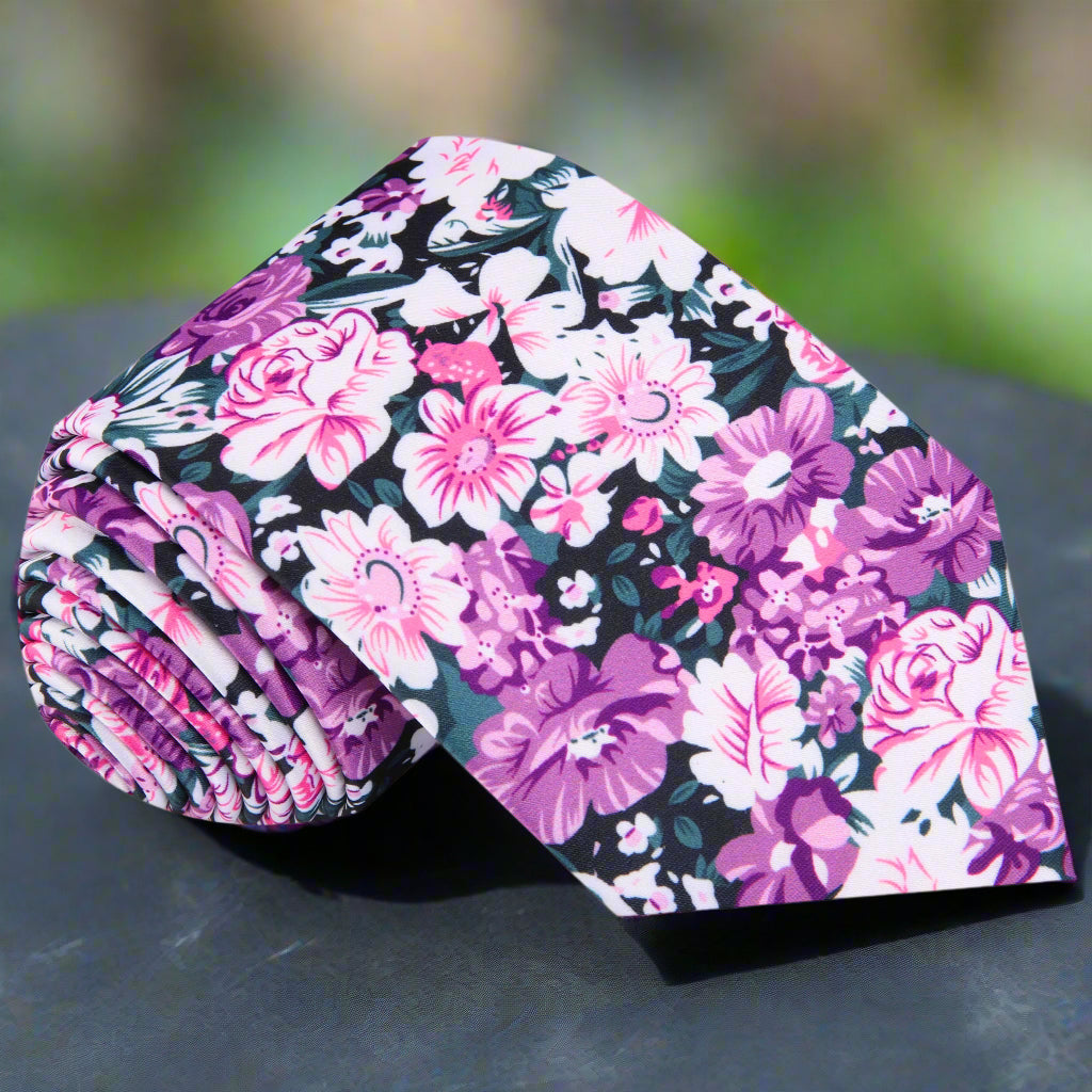 Front view of pink floral silk tie with green and white accents, ideal for garden parties