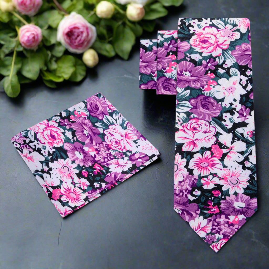 Front view of pink floral silk tie with green and white accents, ideal for garden parties