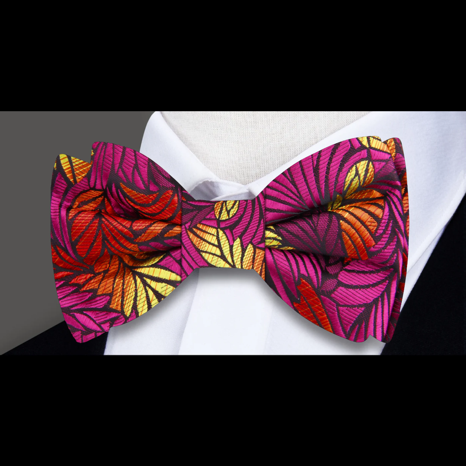 Close-up view of colorful abstract feather bow tie showcasing intricate patterns and vibrant colors.