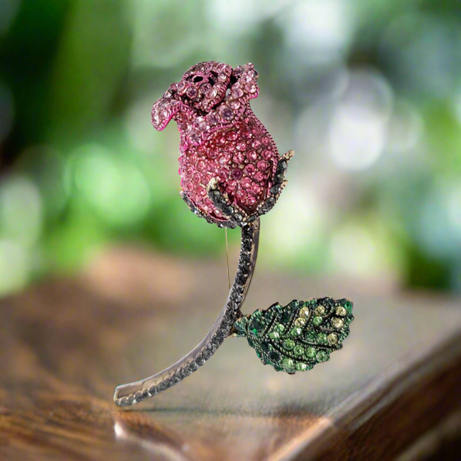 Close-up of a red rose lapel pin with sparkling gemstones, ideal for formal events.