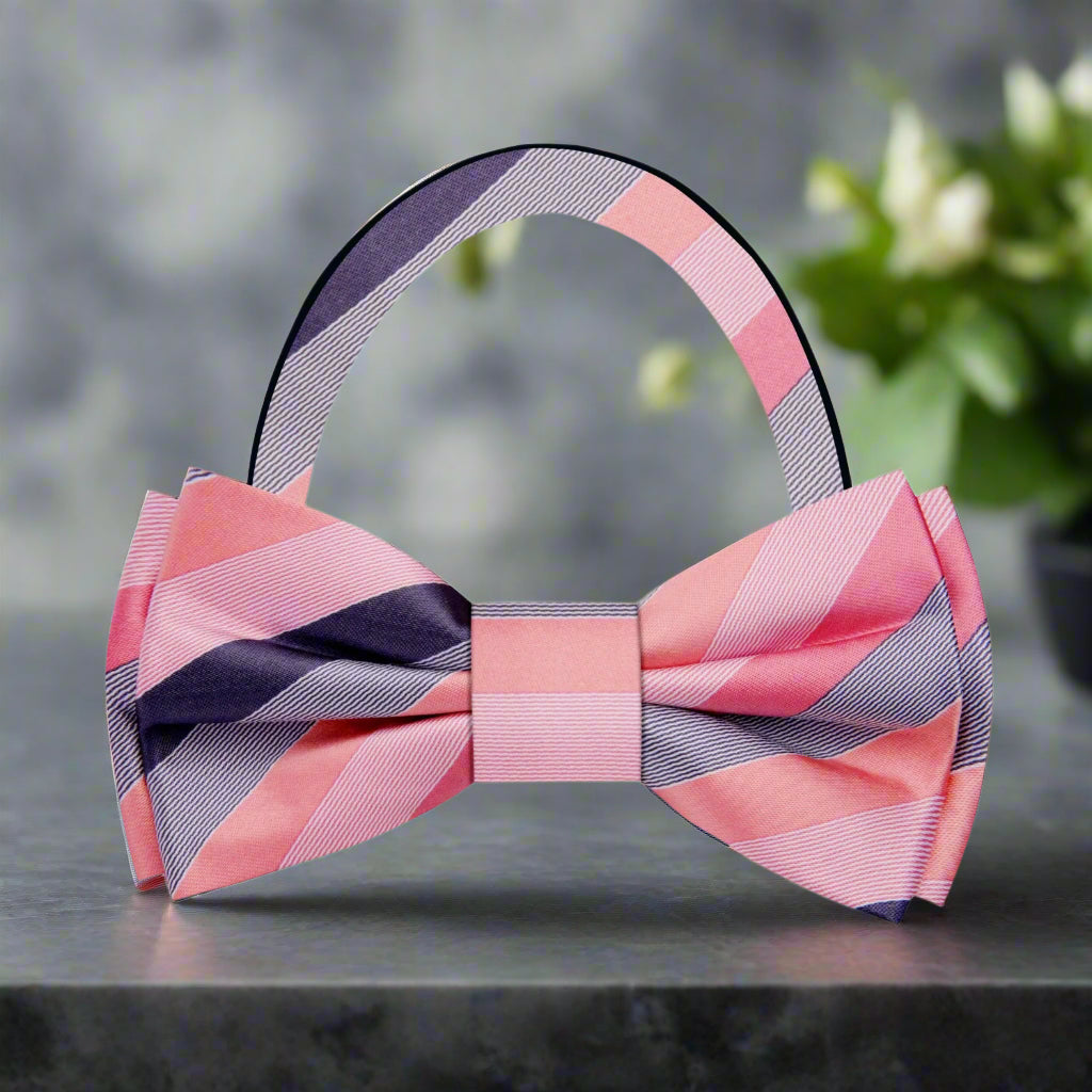 Close-up of charming pastel striped bow tie against a light background.