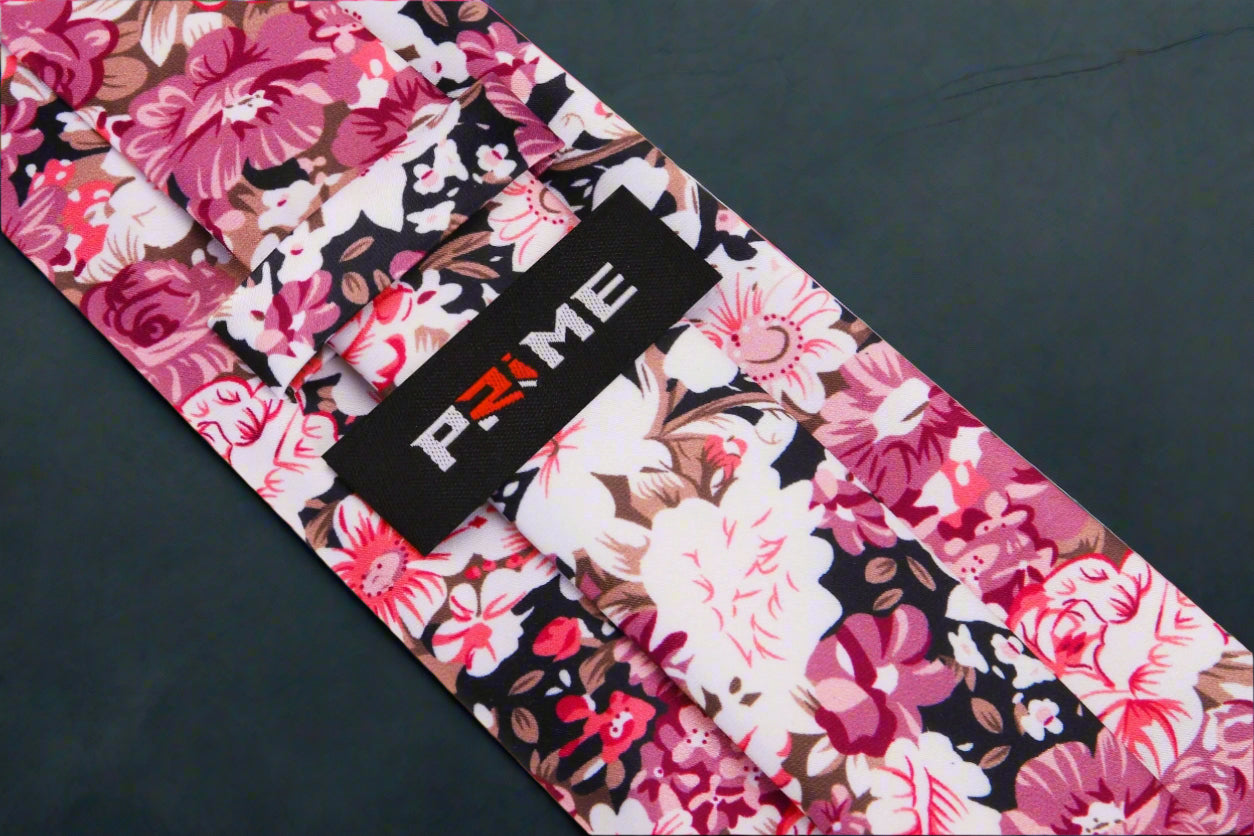 Elegant floral bow tie paired with a light pink dress shirt for a refined look.