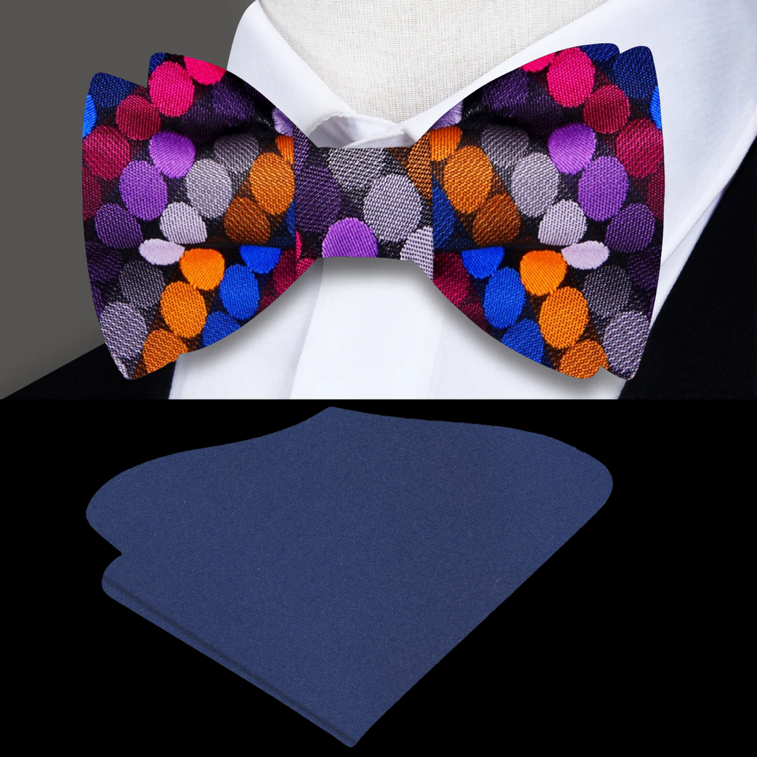 Close-up of vibrant polka dot self-tie bow tie in silk, showing red, blue, and orange dots on purple fabric