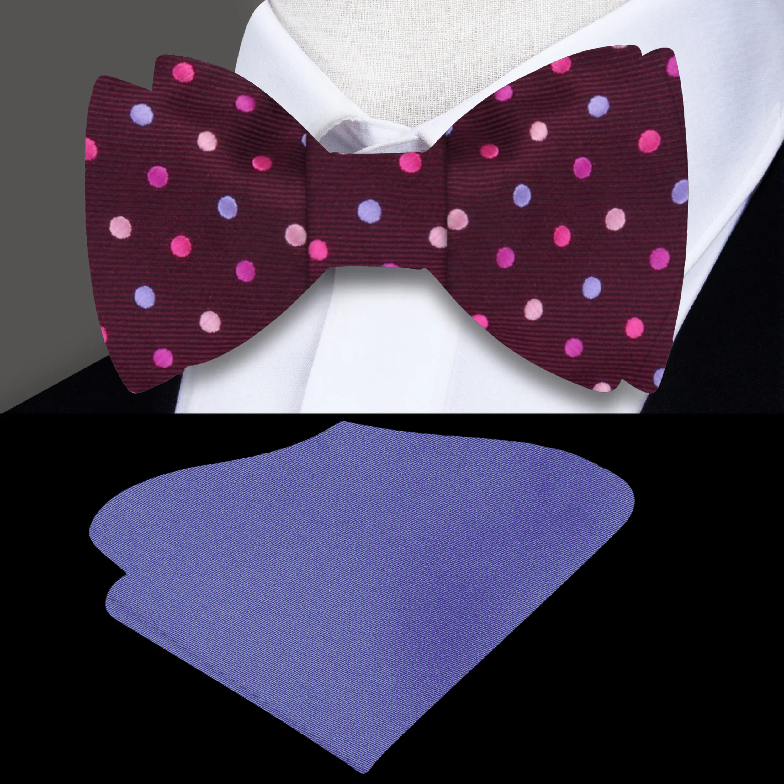 Close-up view of a polka dot silk self tie bow tie in plum with coral, pink, and purple dots