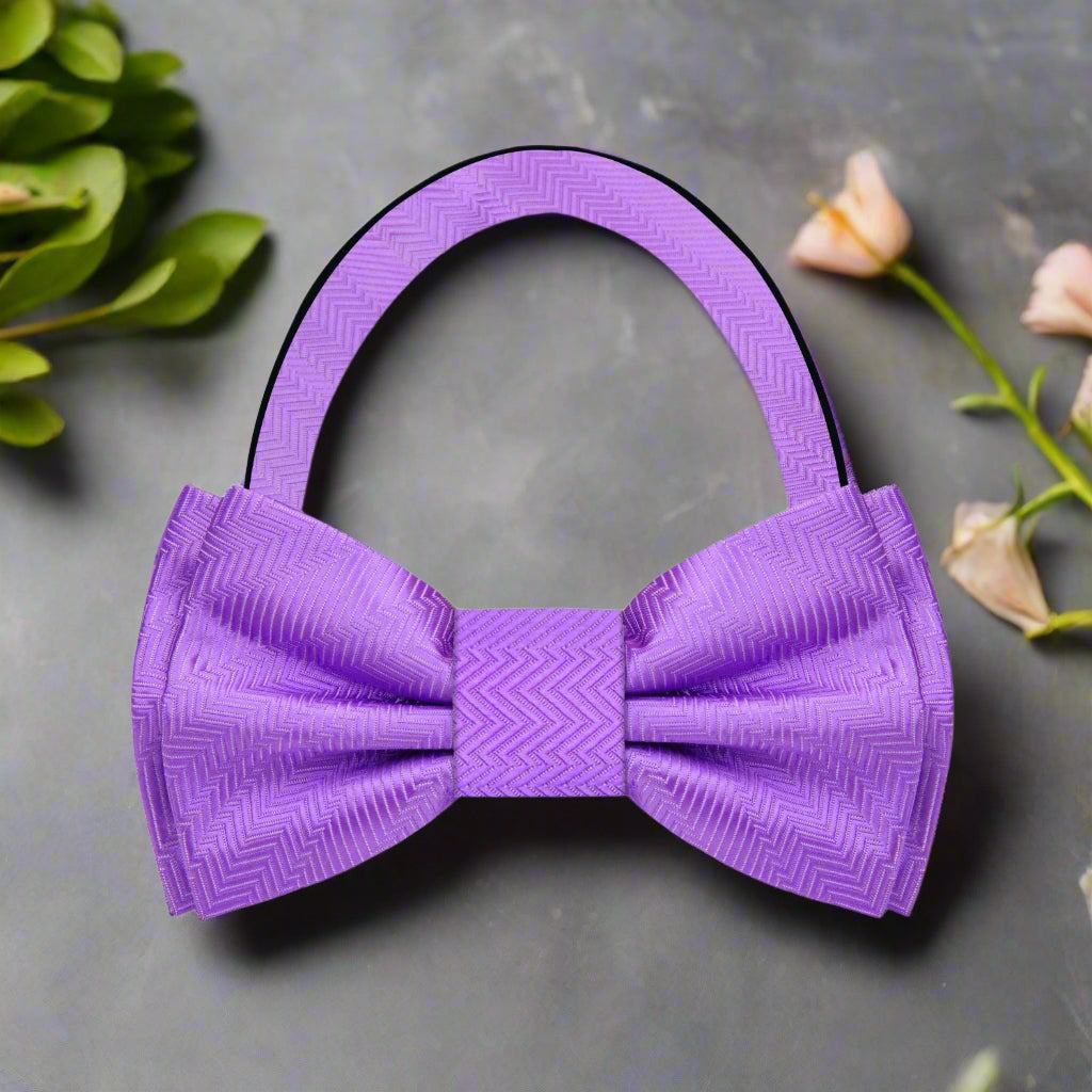Elegant pink and purple lined texture bow tie worn with a white dress shirt