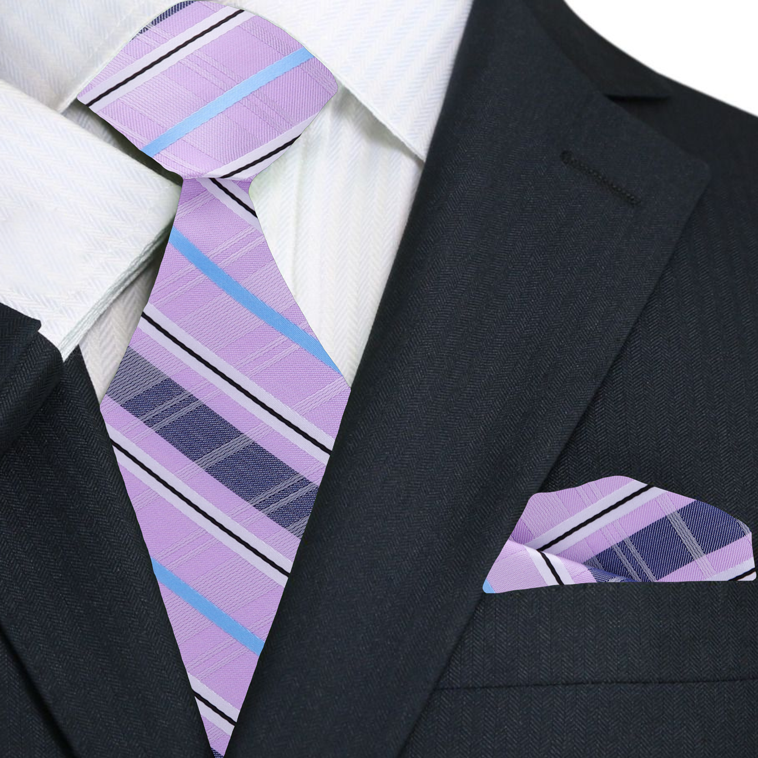 Man wearing a plaid silk necktie with a white dress shirt and navy blazer at a wedding