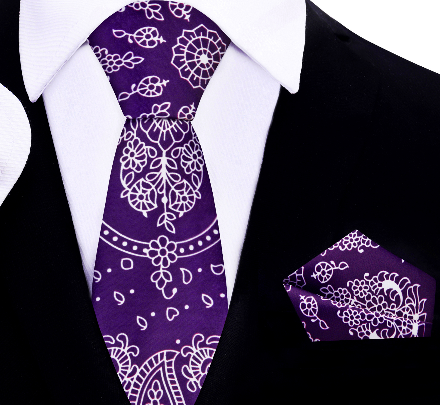 Model wearing a red paisley silk necktie paired with a navy suit for a formal event.