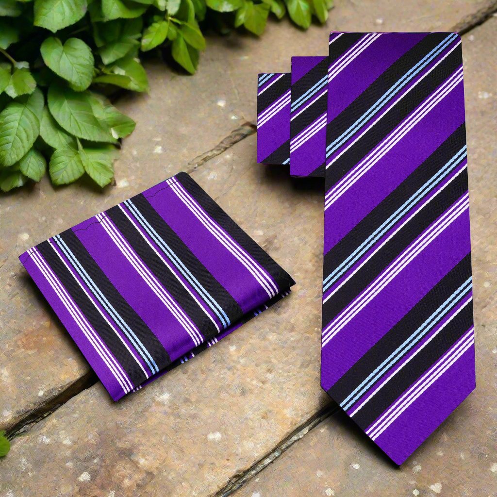 Man adjusting a silk necktie with bold stripe pattern for a wedding or business event