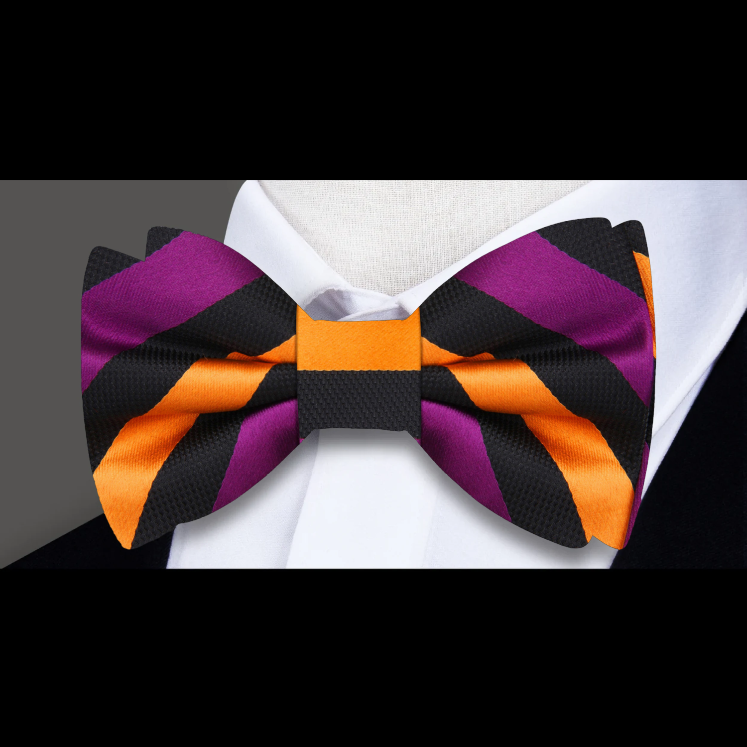 Man adjusting his bow tie at a wedding, featuring a black and white stripe pattern for a classic look.