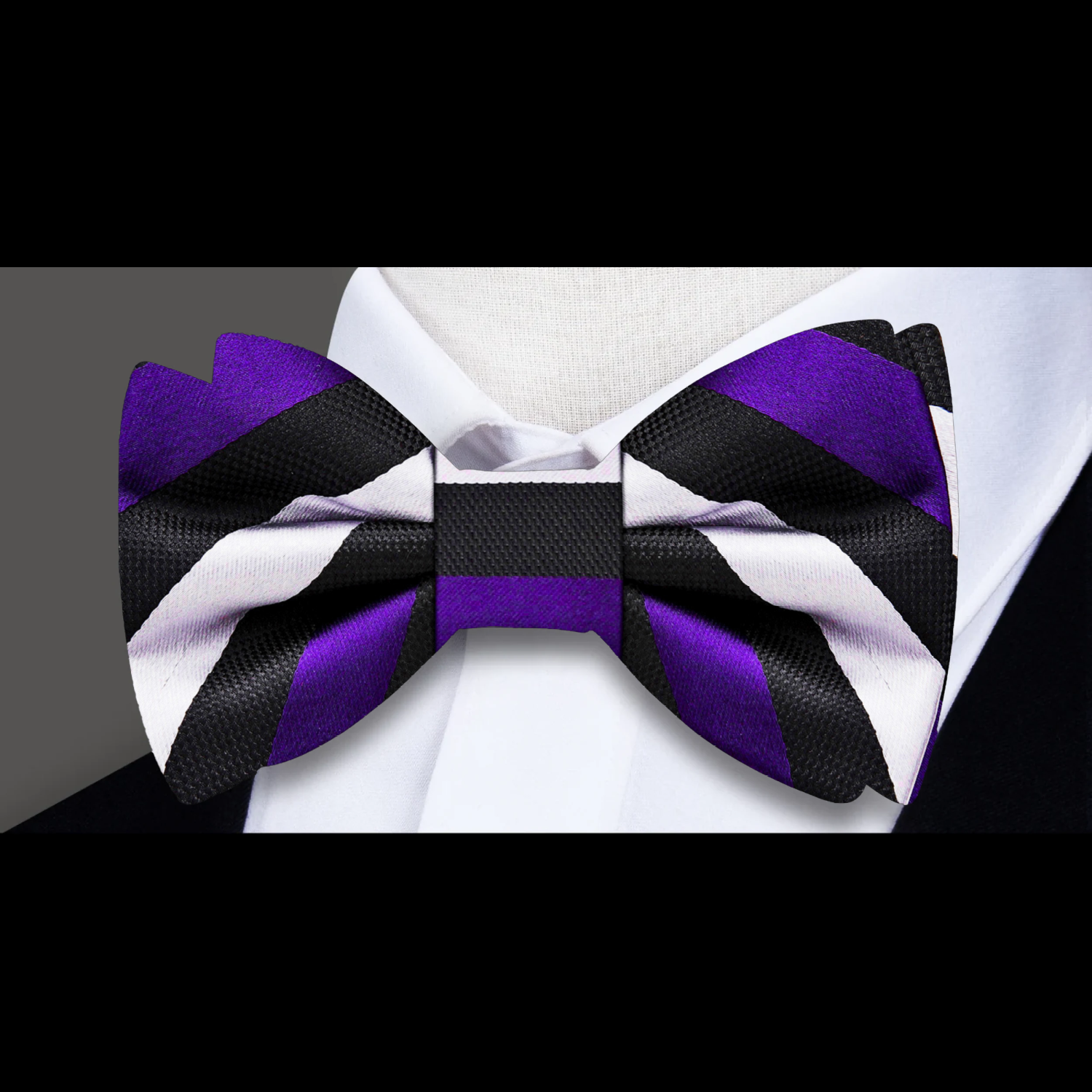 Elegant man at a gallery opening wearing a navy and white stripe bow tie, adding personality to his outfit.
