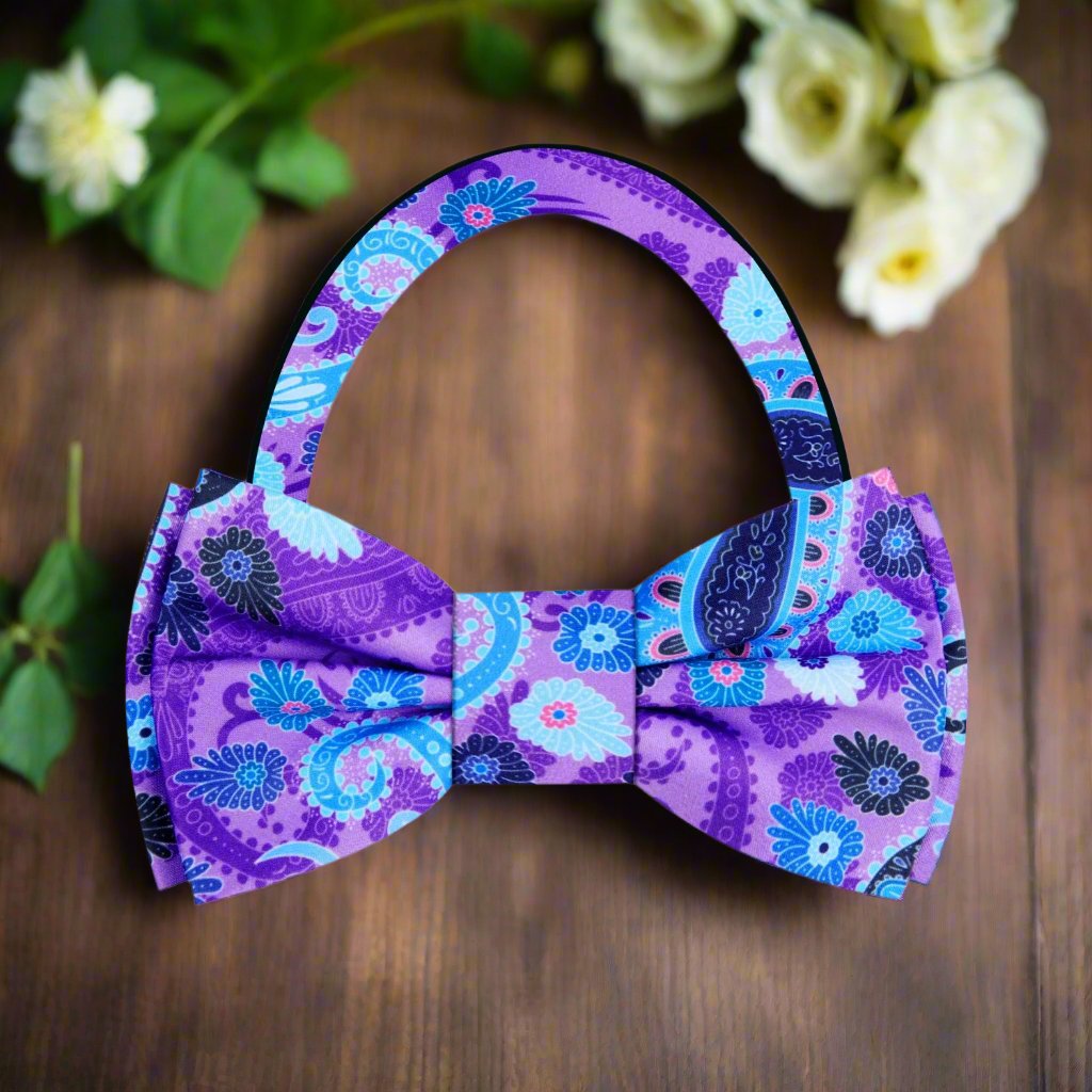 Detail shot of the vibrant paisley bow tie on a navy suit, highlighting the contrast and sophistication.