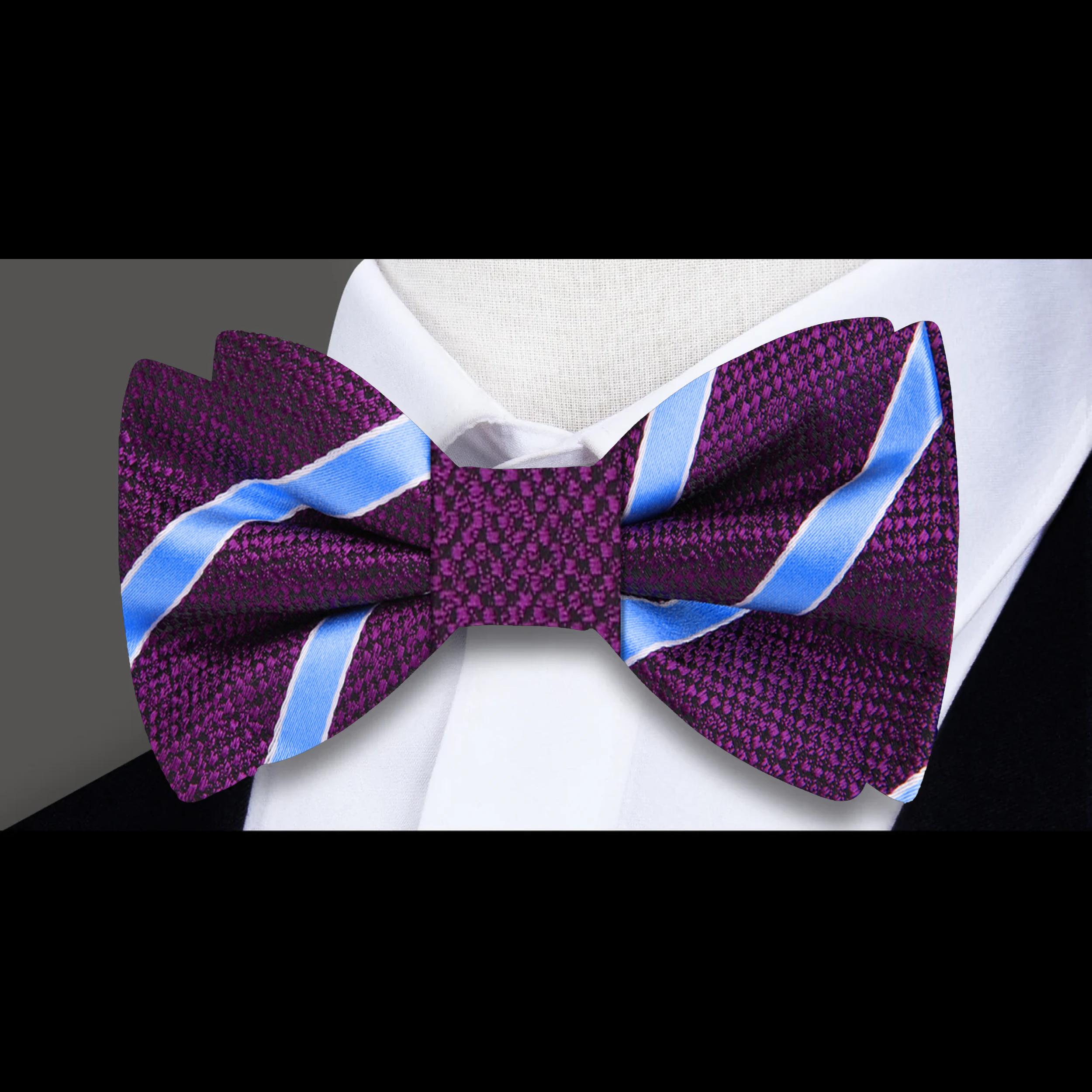 Man adjusting a stylish purple bow tie with pocket square for a wedding