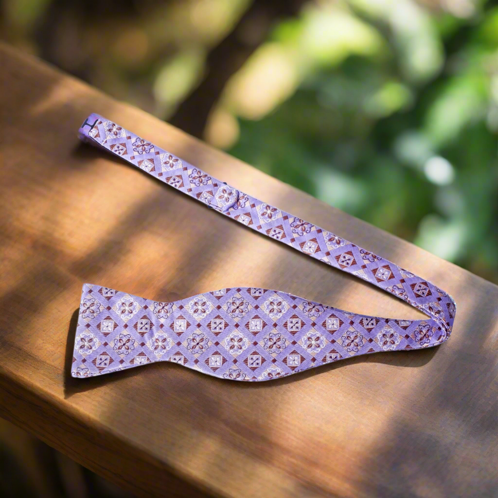 Front view of a geometric self-tie bow tie in light purple and brown for men's fashion