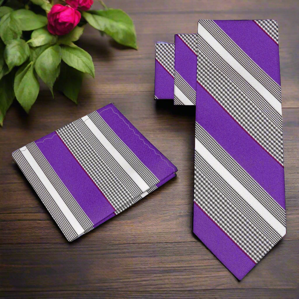 Styled image of the purple striped necktie paired with a white dress shirt and charcoal suit.