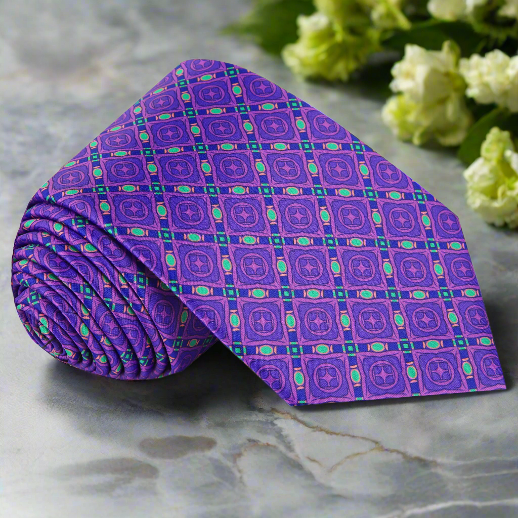Rutherford Geometric Silk Necktie displayed on a formal shirt, showcasing its rich colors and unique pattern.
