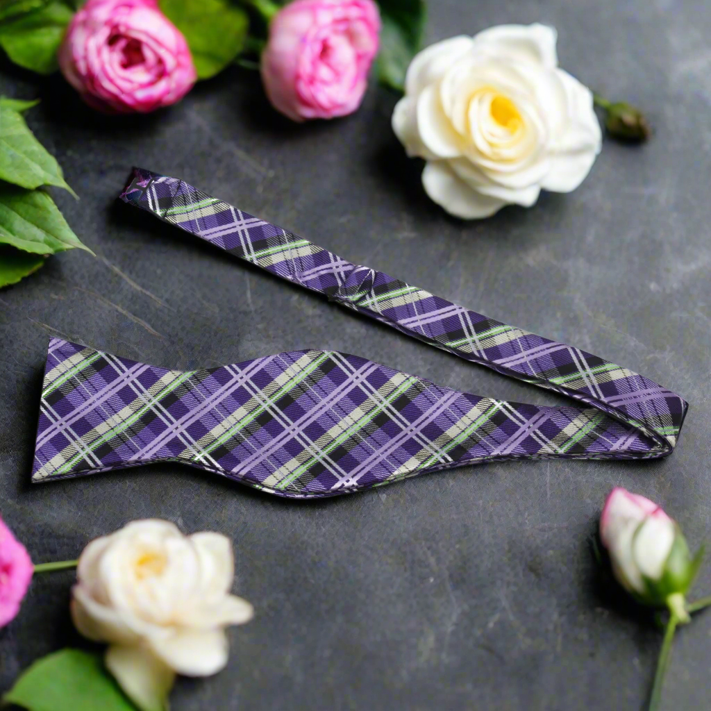 Close-up of a silk plaid self-tie bow tie, showing detailed pattern and texture