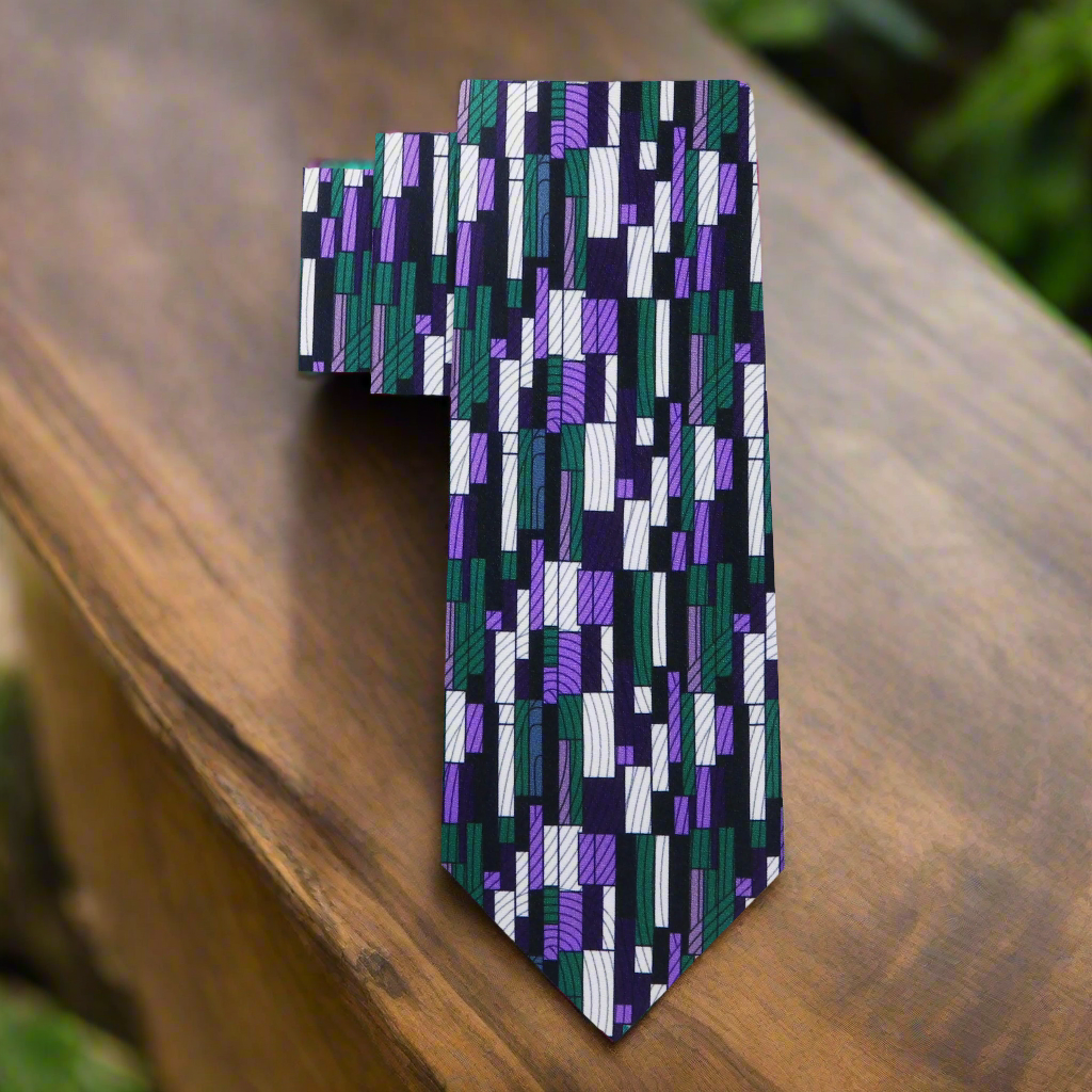 Elegant Kente silk necktie displayed against a crisp white dress shirt, highlighting its vibrant colors.