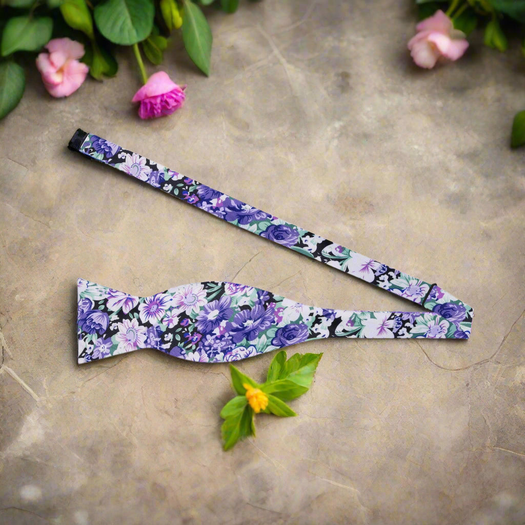 Close-up of silk floral bow tie showcasing intricate floral design in shades of purple and green