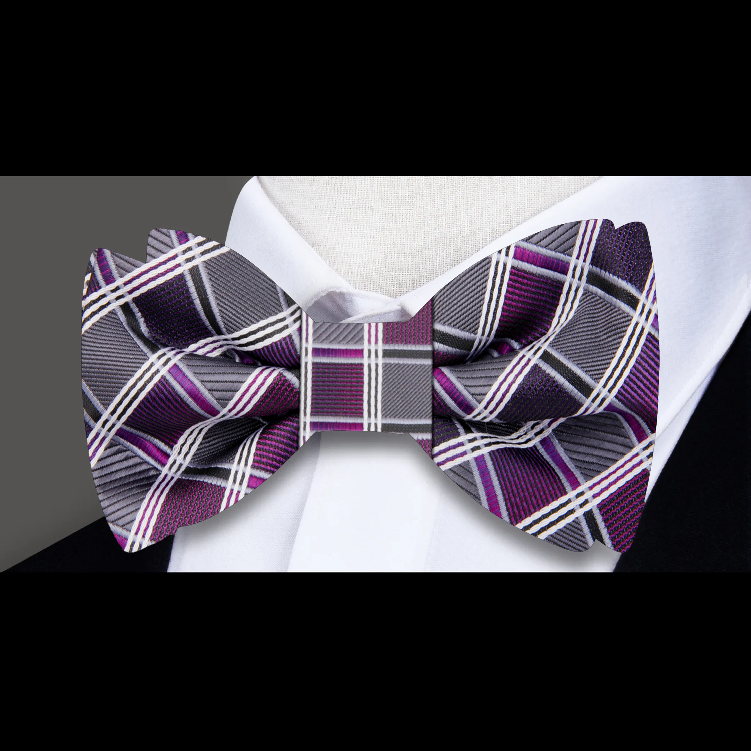 Close-up of the silk fabric and diamond plaid pattern of the mens plaid bow tie