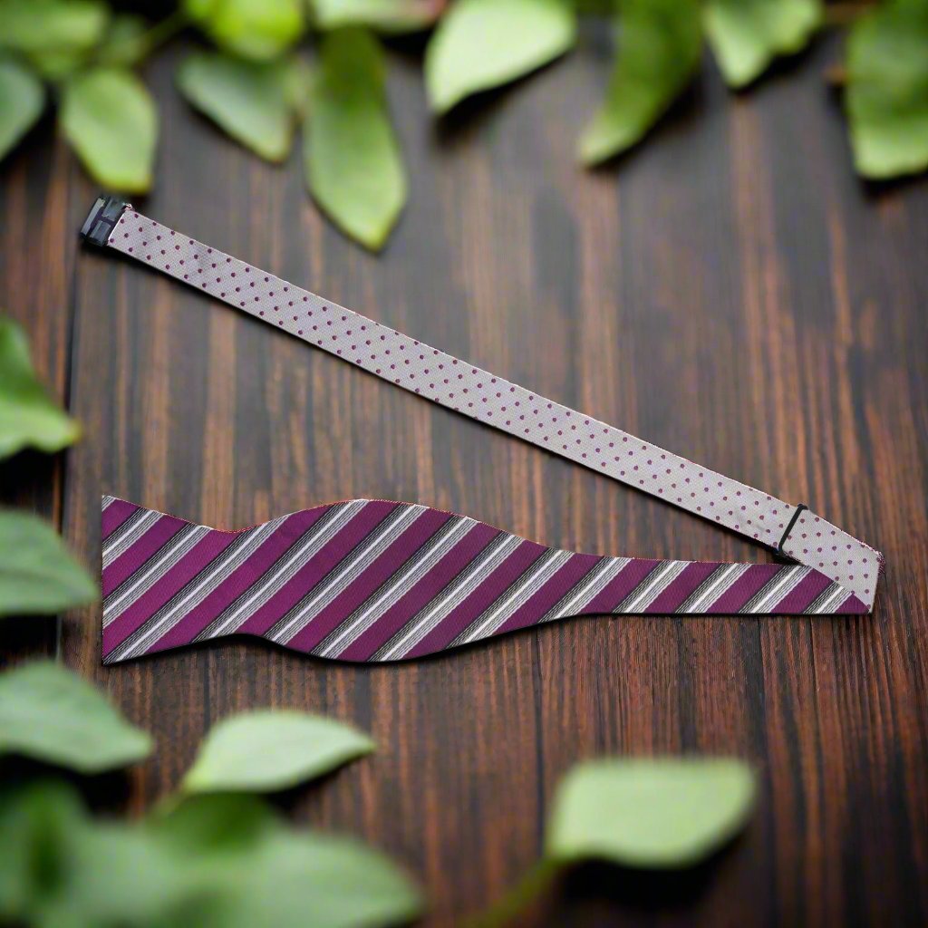 Styled shot of silk bow tie with purple and silver patterns for formal occasions