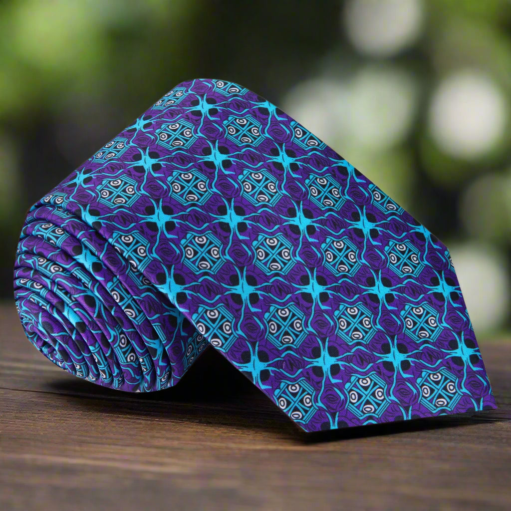Geometric necktie in shades of blue and purple displayed elegantly on a suit.