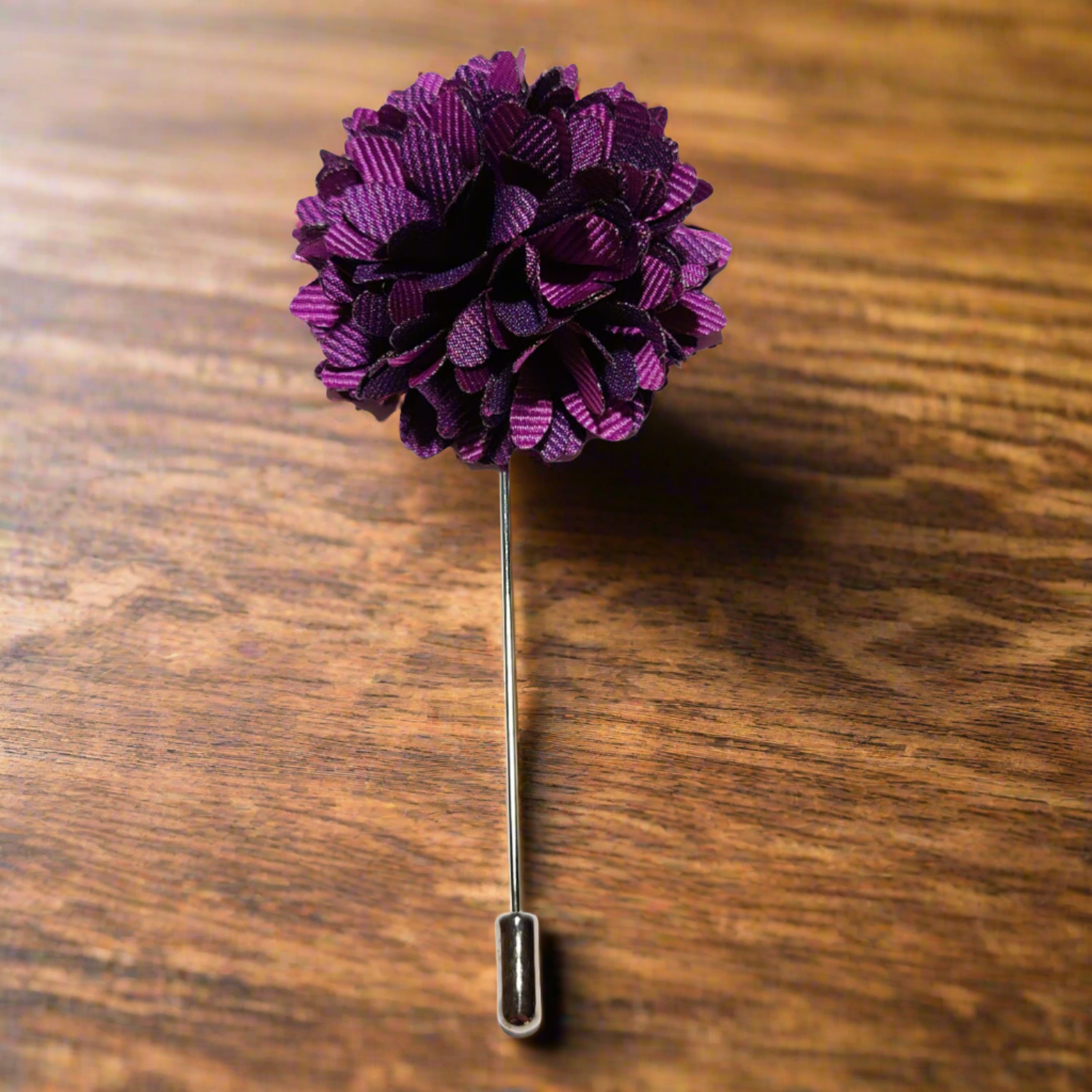 Regal Blossom lapel pin displayed on a rustic background, emphasizing its handcrafted quality.