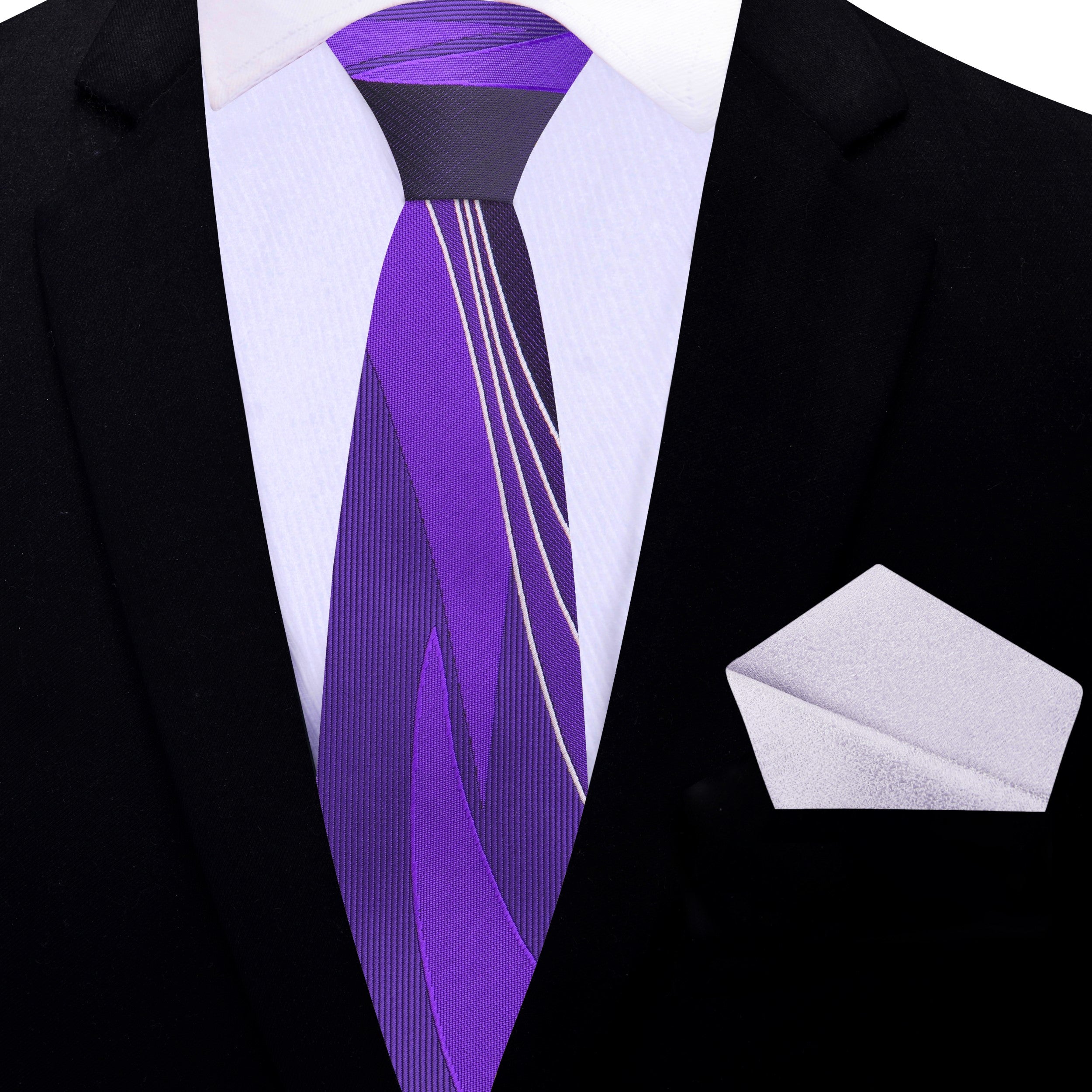 Purple necktie laid alongside a light grey dress shirt and dark grey suit for styling inspiration.