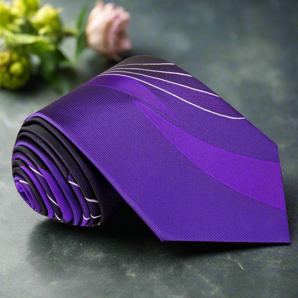 Vibrant purple silk necktie with abstract design, displayed on a formal shirt.