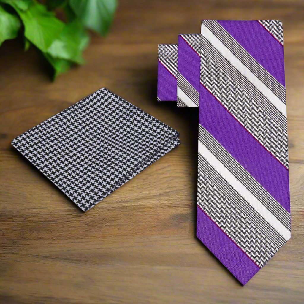 Styled image of the purple striped necktie paired with a white dress shirt and charcoal suit.