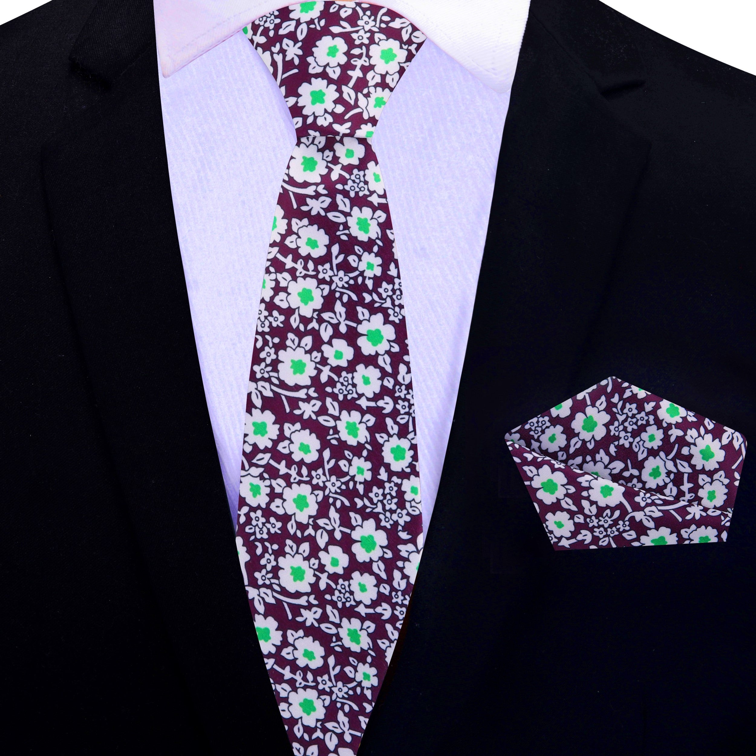 Close-up of plum silk tie with white and green floral pattern, ideal for weddings