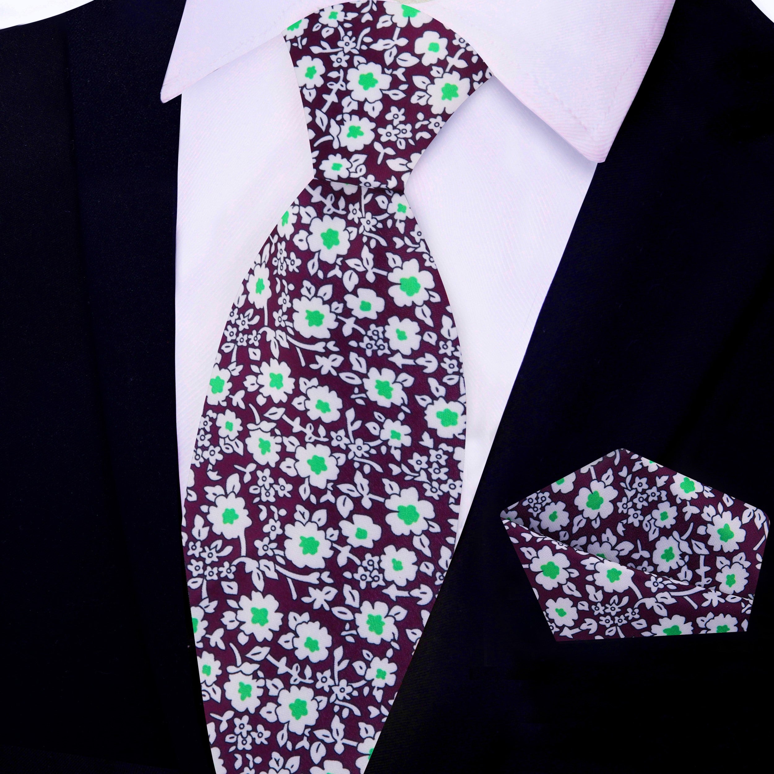 Flat lay of silk necktie and matching pocket square in plum floral design